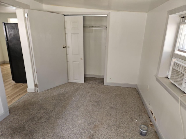 unfurnished bedroom with light wood-type flooring and a closet