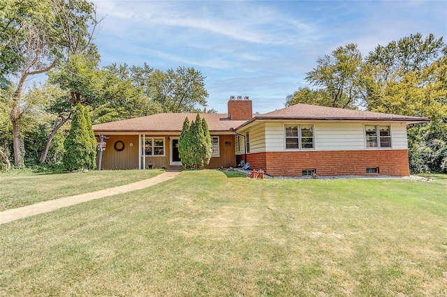 single story home featuring a chimney and a front yard