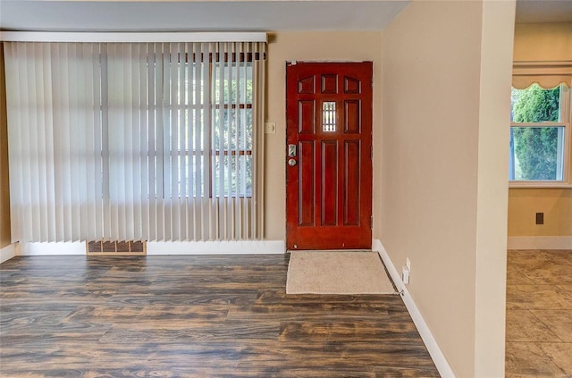 entrance foyer with wood finished floors, visible vents, and baseboards