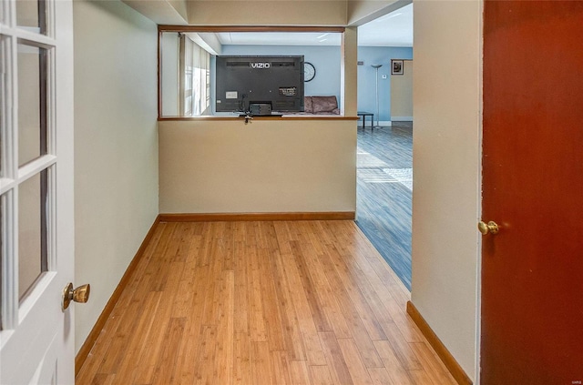 interior space featuring baseboards and wood finished floors