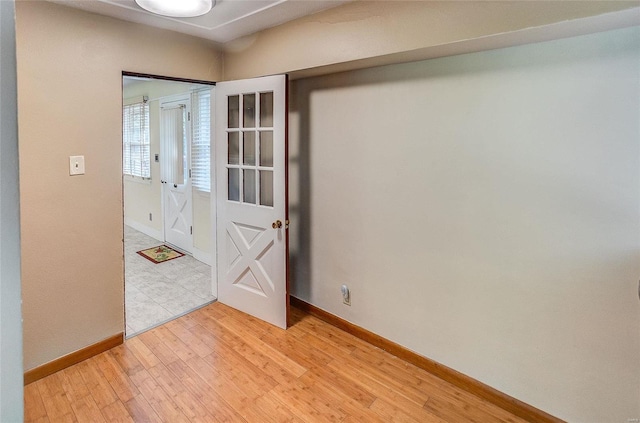 empty room featuring light wood-style floors and baseboards