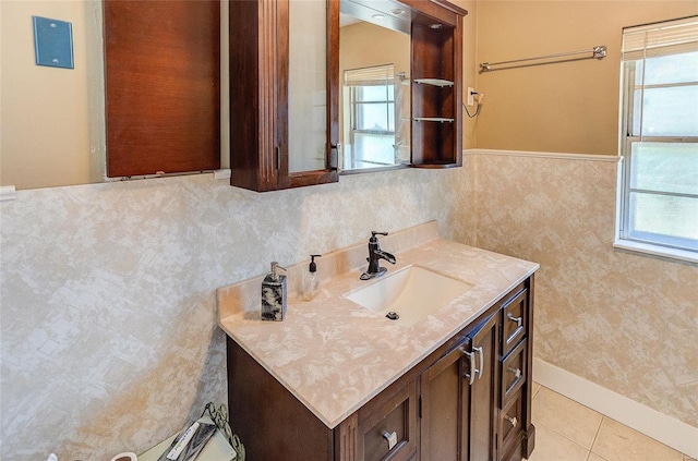 bathroom featuring a healthy amount of sunlight, wainscoting, vanity, and tile patterned floors