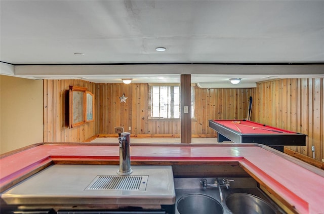 game room with billiards, wood walls, and a sink