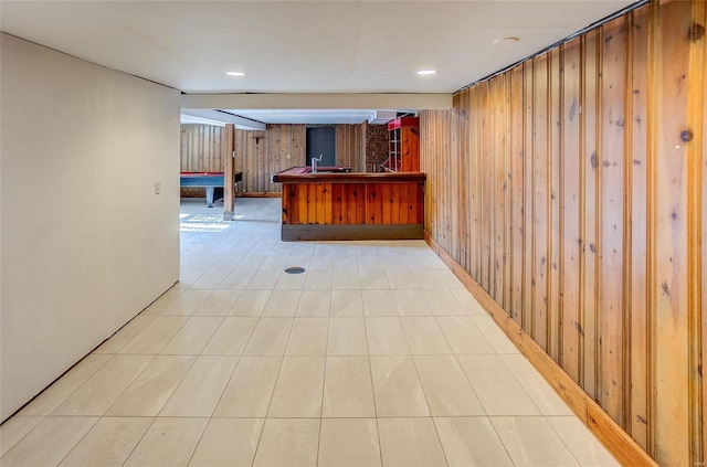 bar featuring a bar and wood walls