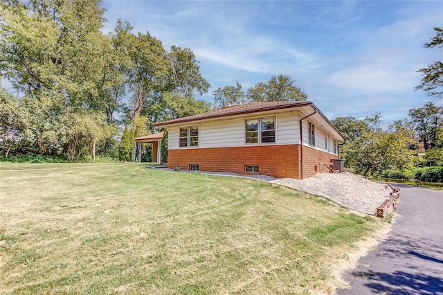 exterior space with a front yard, brick siding, and driveway