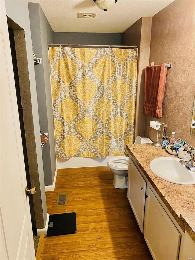 bathroom with vanity, hardwood / wood-style flooring, and toilet