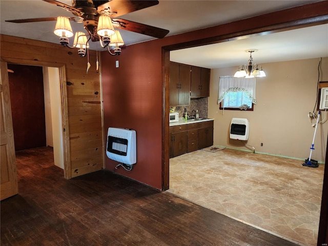 kitchen featuring decorative backsplash, dark wood-style flooring, heating unit, and white microwave