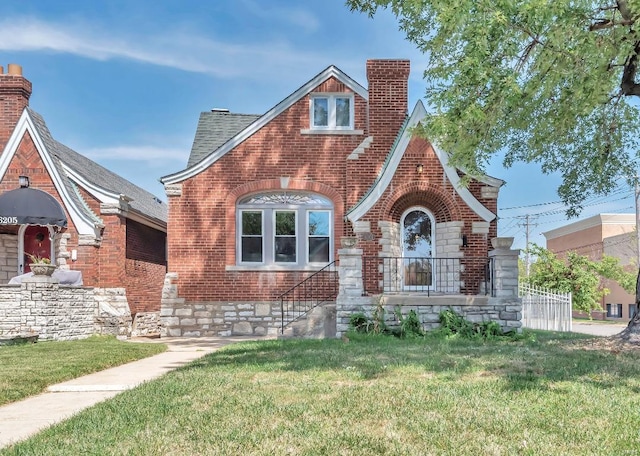 tudor house featuring a front yard