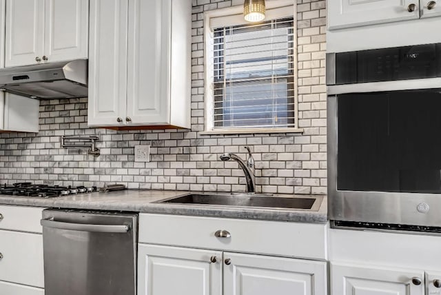 kitchen featuring white cabinetry, backsplash, sink, and stainless steel appliances