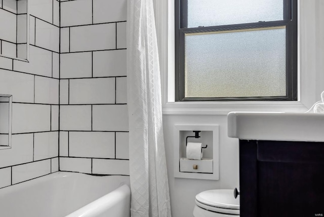 bathroom featuring shower / bath combination with curtain, plenty of natural light, and toilet