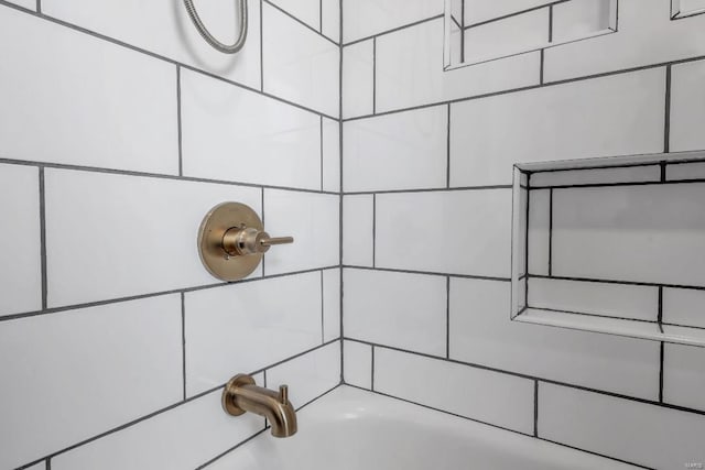 interior details featuring bathtub / shower combination