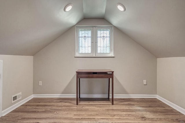 bonus room with vaulted ceiling and wood-type flooring