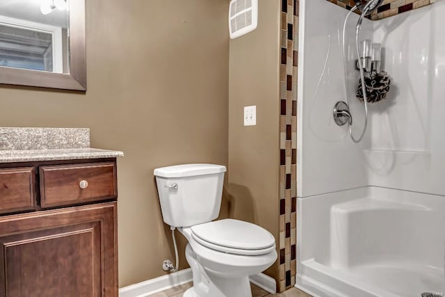 bathroom featuring a shower, tile patterned floors, vanity, and toilet