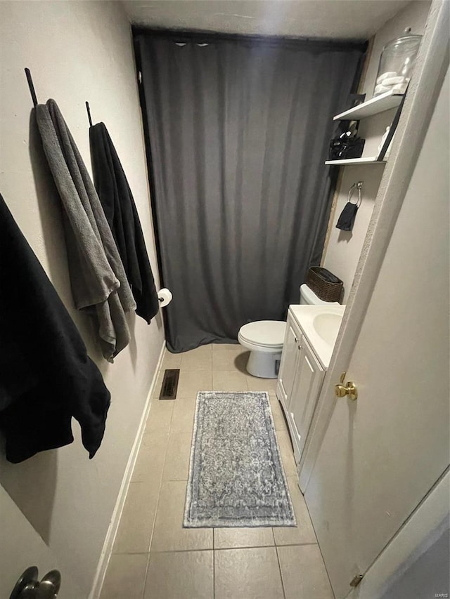 bathroom with tile patterned floors, toilet, and vanity