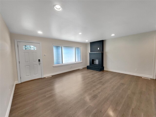 unfurnished living room featuring hardwood / wood-style flooring and a fireplace