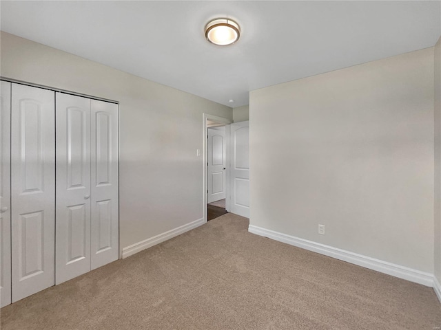 unfurnished bedroom with carpet flooring and a closet