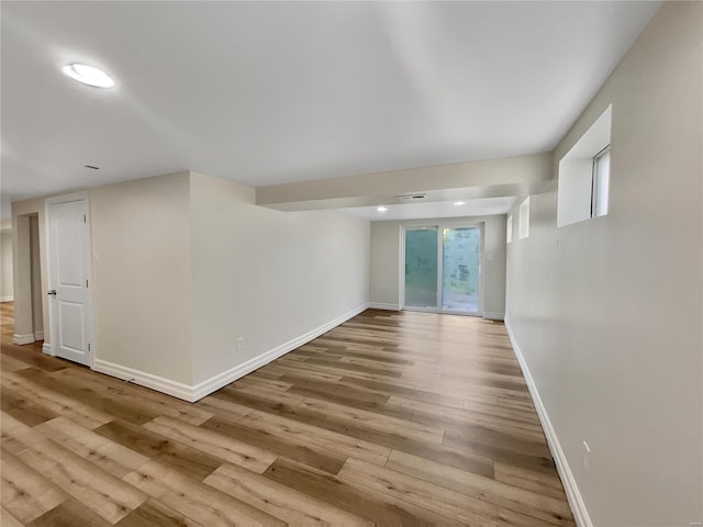 spare room with light hardwood / wood-style flooring