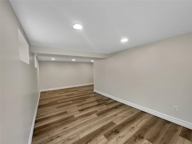 basement with light hardwood / wood-style floors