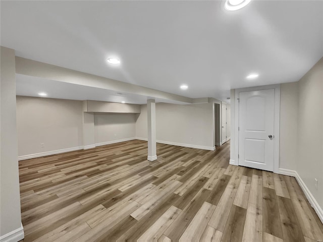 basement with light hardwood / wood-style floors