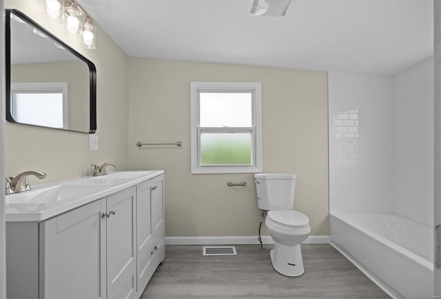 full bath featuring visible vents, a sink, toilet, and wood finished floors