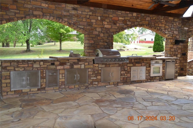 view of patio / terrace with ceiling fan and area for grilling