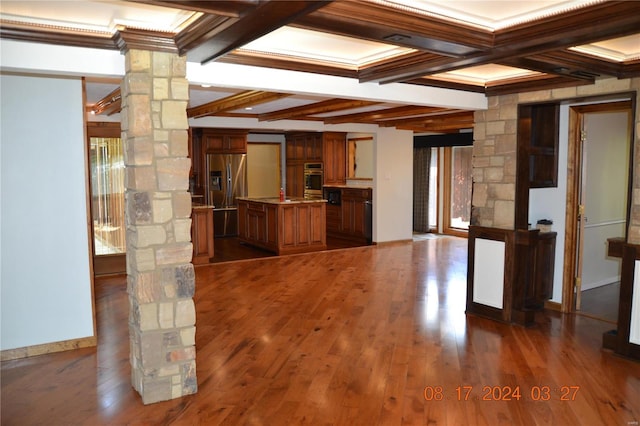 interior space with dark hardwood / wood-style flooring, coffered ceiling, beam ceiling, and ornate columns