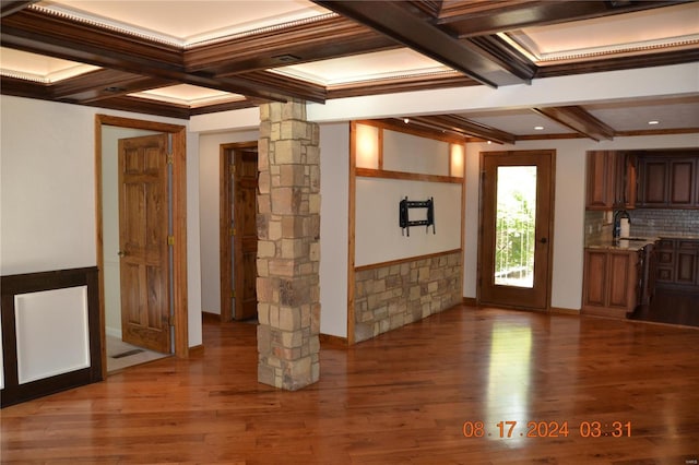 interior space with coffered ceiling, ornamental molding, ornate columns, hardwood / wood-style flooring, and sink