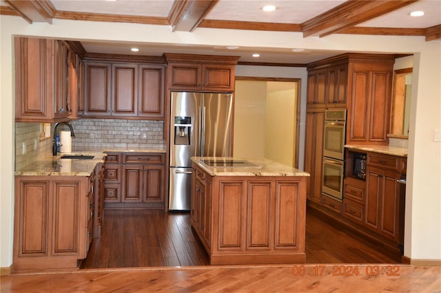 kitchen with a kitchen island, dark hardwood / wood-style flooring, tasteful backsplash, sink, and stainless steel appliances