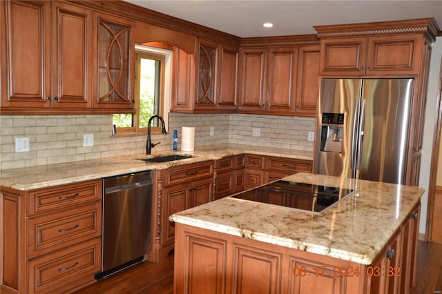 kitchen with dark hardwood / wood-style floors, a center island, stainless steel appliances, and backsplash