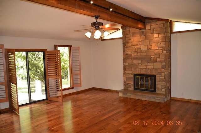 unfurnished living room with ceiling fan, vaulted ceiling with beams, hardwood / wood-style flooring, and a fireplace