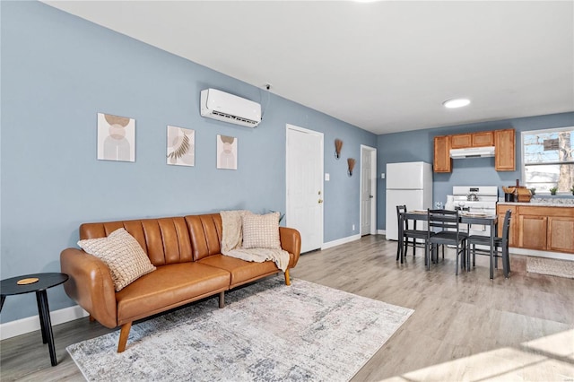 living room featuring light hardwood / wood-style floors and a wall unit AC