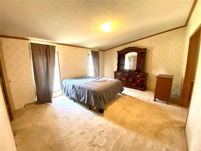 bedroom featuring light carpet, crown molding, a textured ceiling, and wallpapered walls