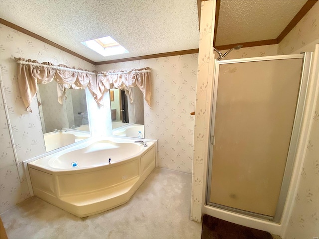 full bathroom with a stall shower, a skylight, a textured ceiling, and wallpapered walls