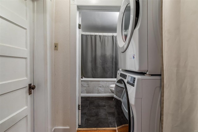 laundry area featuring laundry area and stacked washer / drying machine