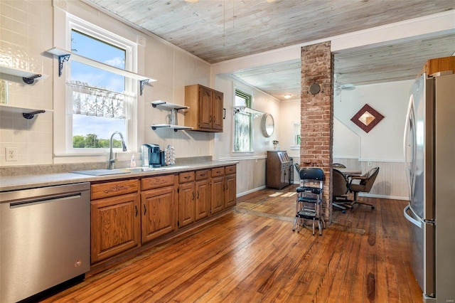 kitchen featuring stainless steel appliances, wood finished floors, open shelves, and brown cabinets