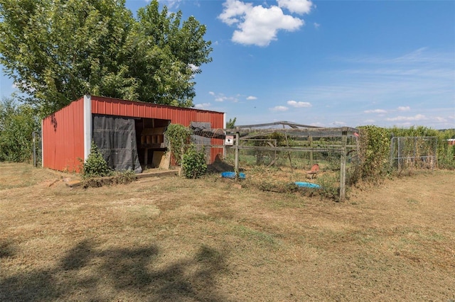 view of yard with an outbuilding and fence