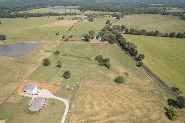 birds eye view of property featuring a water view and a rural view