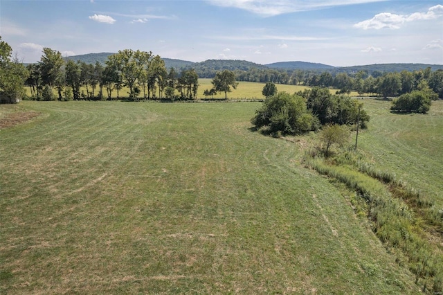 drone / aerial view with a mountain view and a rural view