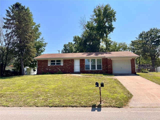 single story home with a garage, a front lawn, concrete driveway, and brick siding