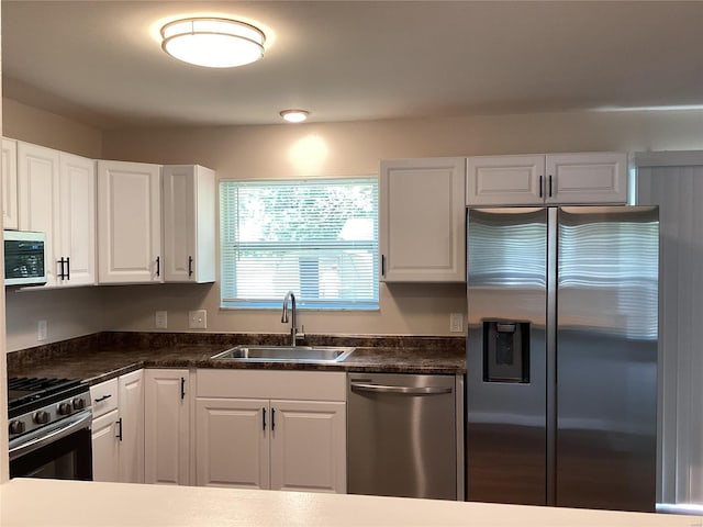 kitchen with white cabinets, sink, and appliances with stainless steel finishes