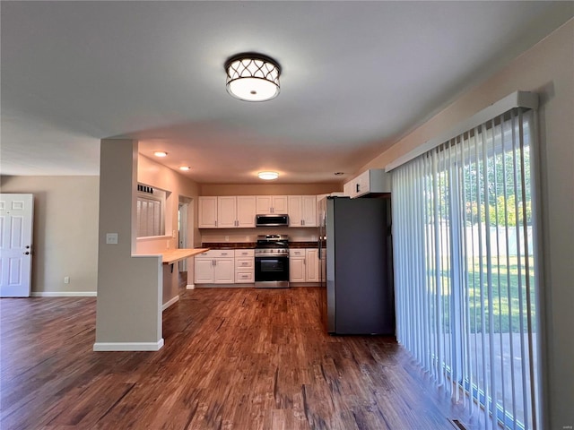 kitchen with white cabinetry, dark wood-type flooring, and appliances with stainless steel finishes