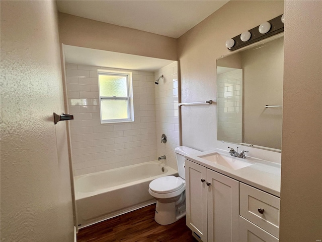 full bathroom featuring vanity, toilet, tiled shower / bath, and hardwood / wood-style flooring