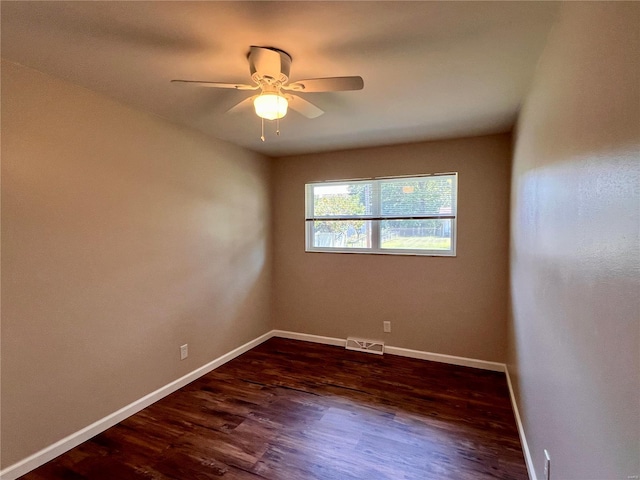 empty room with ceiling fan and dark hardwood / wood-style flooring