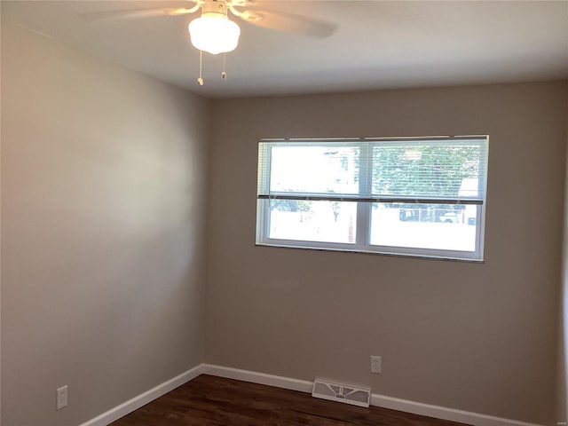 unfurnished room featuring dark hardwood / wood-style flooring and ceiling fan