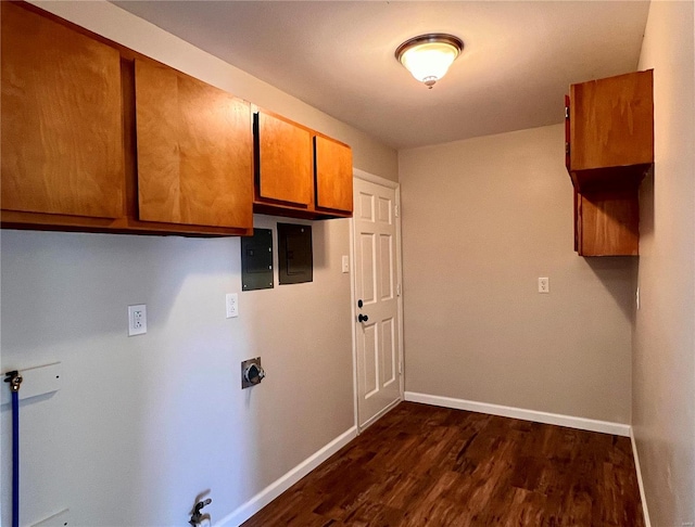 laundry area featuring cabinets, dark hardwood / wood-style floors, gas dryer hookup, and hookup for an electric dryer