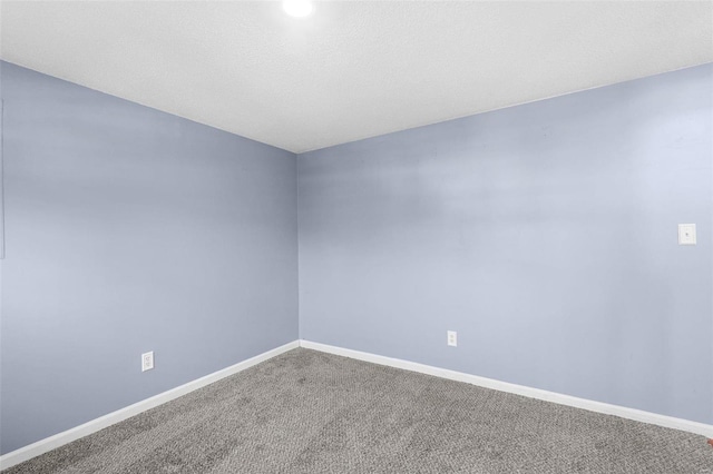 empty room with carpet flooring and baseboards