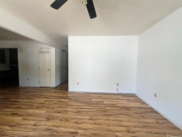 empty room with ceiling fan and wood-type flooring