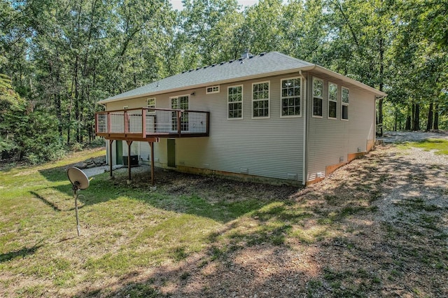 view of home's exterior featuring a yard and a deck