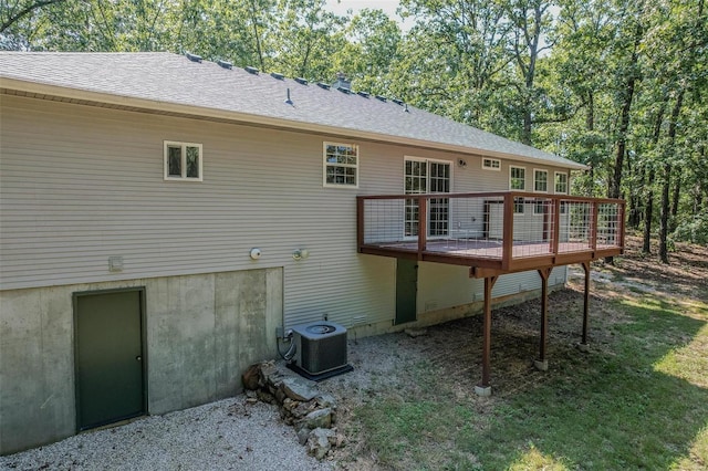 back of house featuring a wooden deck and central AC