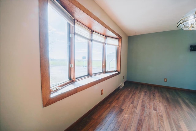 spare room featuring dark hardwood / wood-style floors